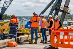 Construction workers conducting site surveying for Brisbane 2032 Olympics inspection at an active infrastructure construction project