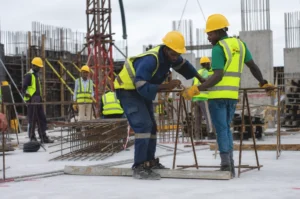 Construction workers installing steel rebar on a commercial construction project
