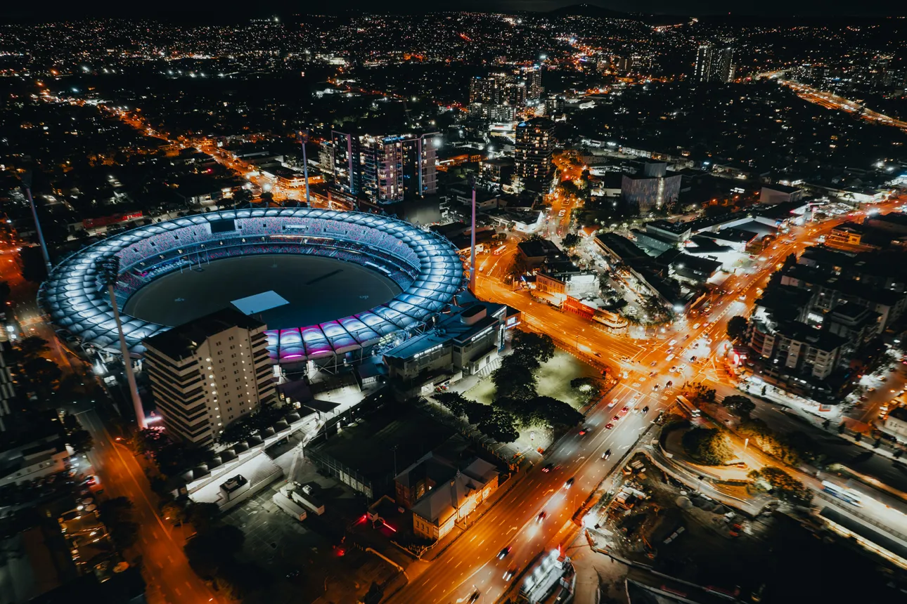 Olympic stadium surrounded by a vibrant city at night
