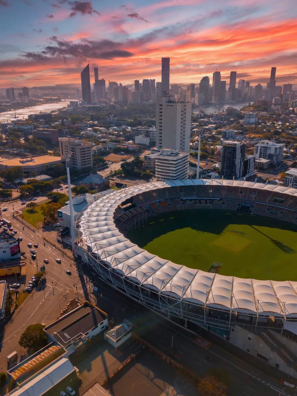 Urban city view featuring a sports stadium and skyscrapers