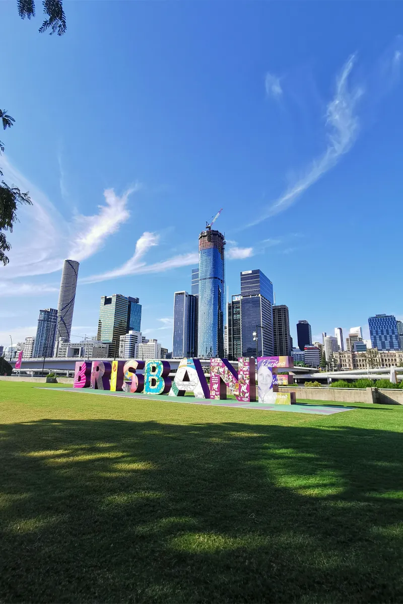 Brisbane sign attraction featuring grass, city views, and urban scenery