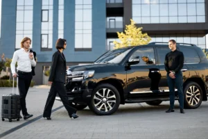Business professionals walking toward a van in formal office attire.
