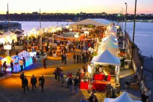 Busy night market filled with shoppers and food stalls.