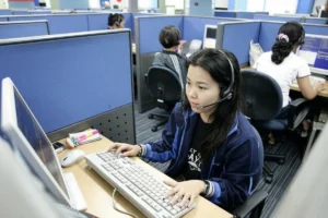 Call center agents assisting customers in a modern customer support office.