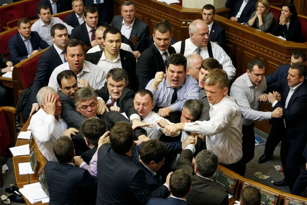 Crowd intervening to stop a fight between two men