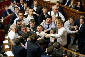 Crowd intervening to stop a fight between two men