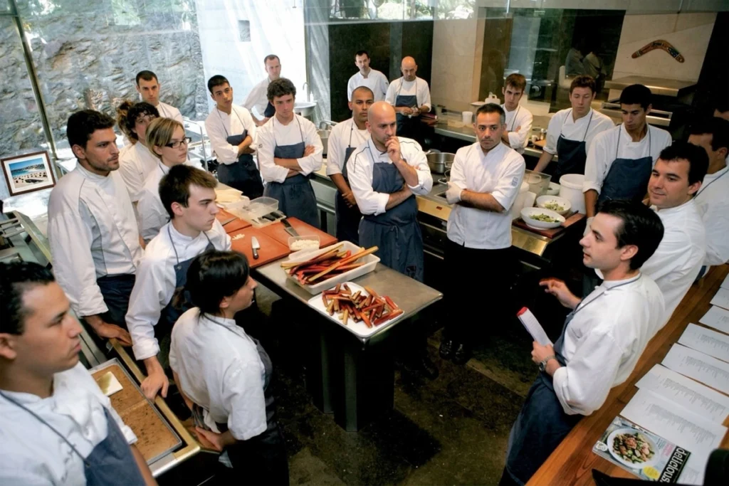 Culinary team attending a kitchen briefing before service.