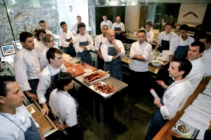Culinary team attending a kitchen briefing before service.