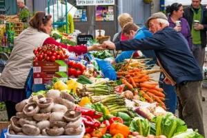 Customer purchasing fresh vegetables from a vendor at a local market.
