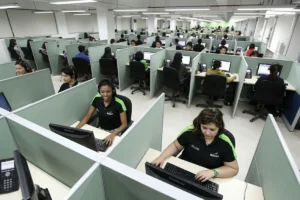Customer support agents wearing headsets while assisting clients.