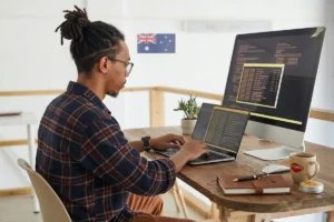 Developer programming at a workstation with  monitors.