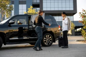 Driver opening a vehicle door for a passenger.