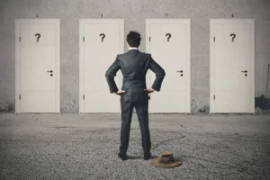 Individual standing in front of multiple doors symbolizing decision-making
