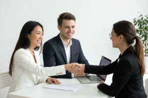 Interviewer shaking hands with a job candidate after an interview.