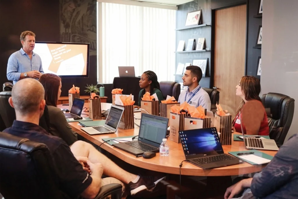 Participants using laptops at the table during business meeting