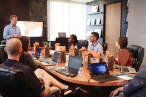Participants using laptops at the table during business meeting