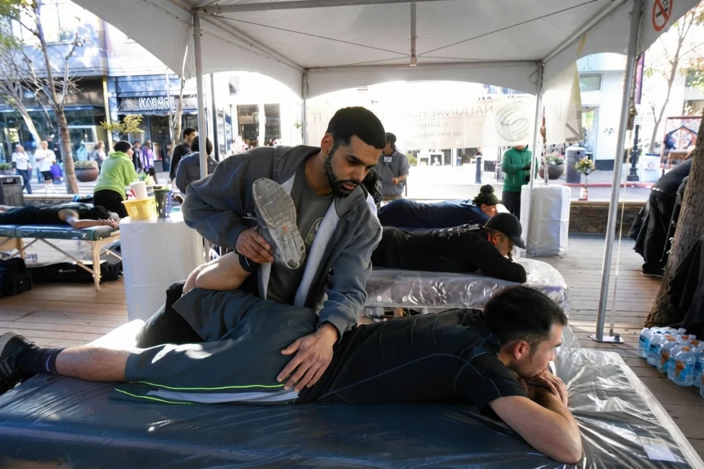 Physical therapist performing muscle therapy on an athlete.