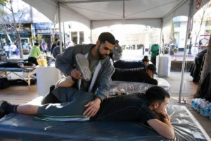 Physical therapist performing muscle therapy on an athlete.