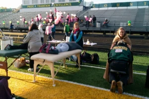 Sports therapist providing a massage to an athlete during recovery.