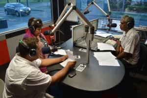 Radio broadcast team working together in a professional radio station.