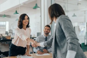 Recruiter shaking hands with a candidate during the hiring process.