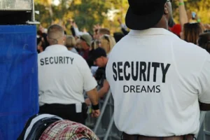 Security guard observing people to maintain safety and order.