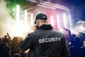 Security guard using an earpiece to coordinate security operations.