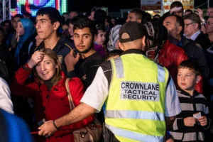 Security personnel maintaining safety by observing people in a public space.