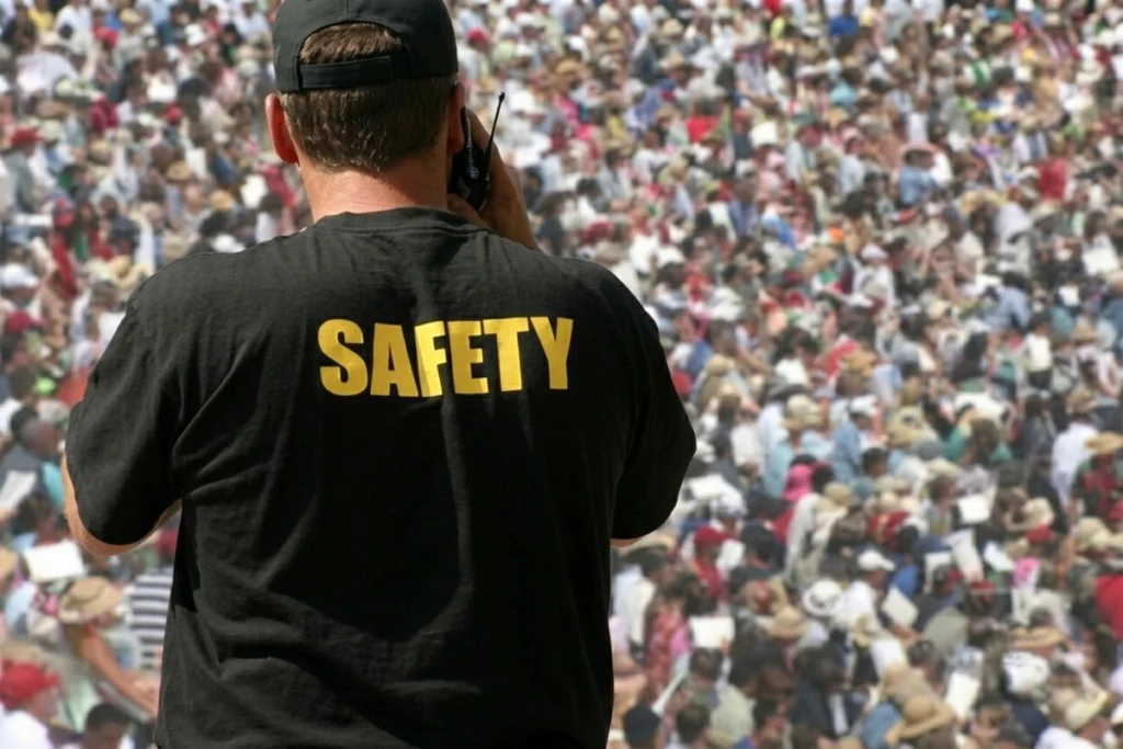 Security personnel monitoring people in a public area.