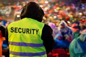 Security staff maintaining safety while observing people from an elevated position.