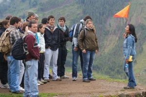 Tour guide leading a group of tourists with a flag