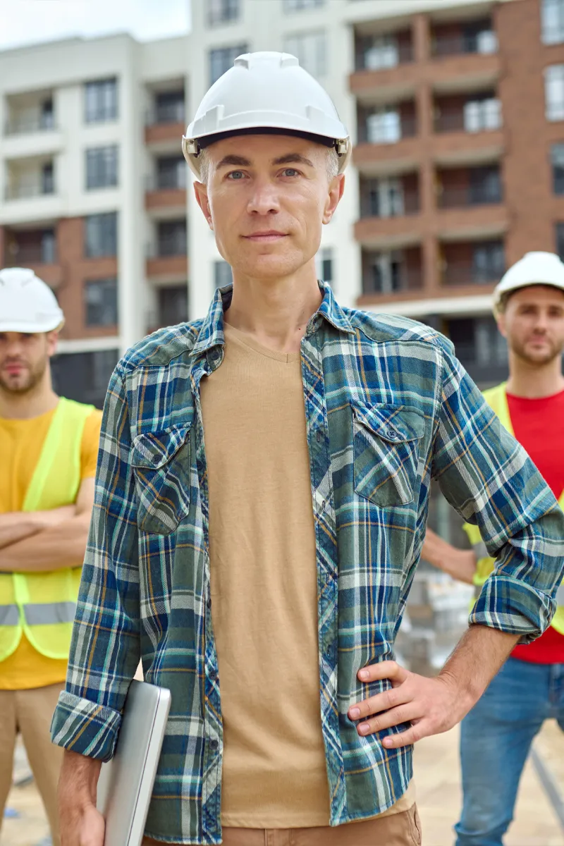 Team of construction workers standing at an active worksite