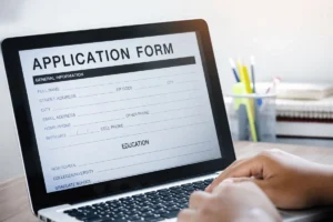 Laptop displaying an online application form.