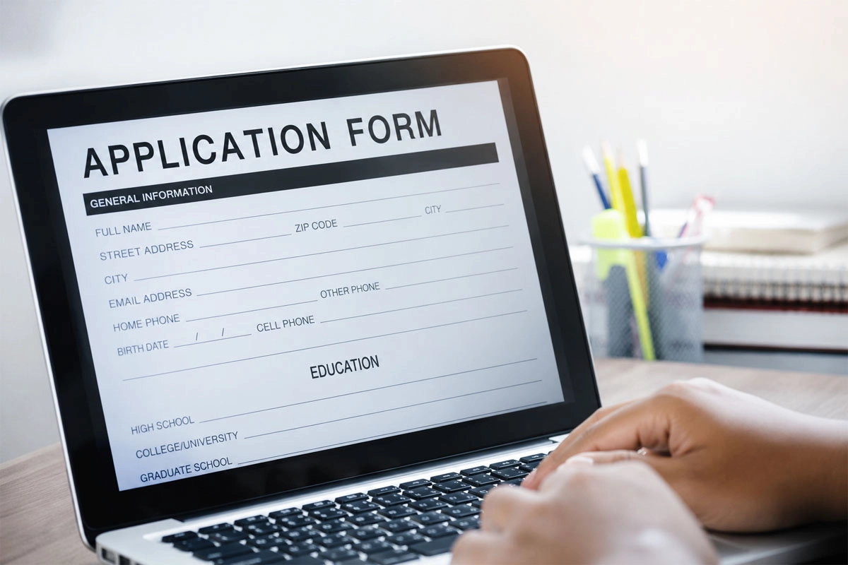 Laptop displaying an online application form.