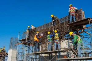 Construction workers welding steel components during bridge construction.