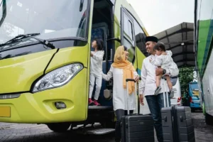 Family boarding a bus through the entrance door.