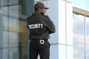 Male security guard turning around with "Security" on the back of his shirt.