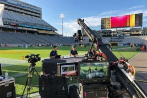 Sports analysts providing halftime commentary during a football game broadcast.