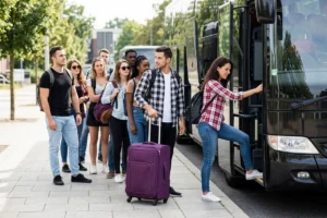 Woman entering a bus while other commuters wait in an orderly line.